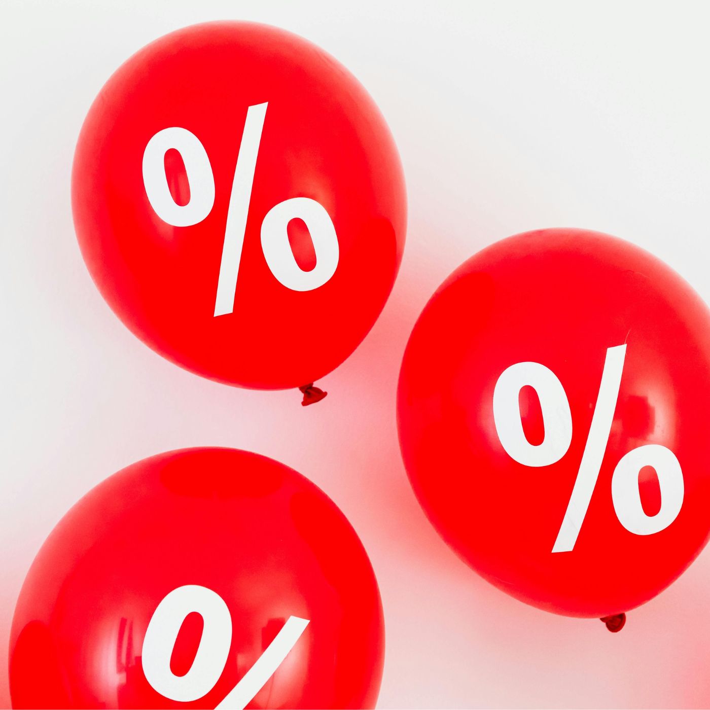 Drei rote Luftballons mit weißen Prozentzeichen, ideal für Verkaufsaktionen oder Rabattaktionen.