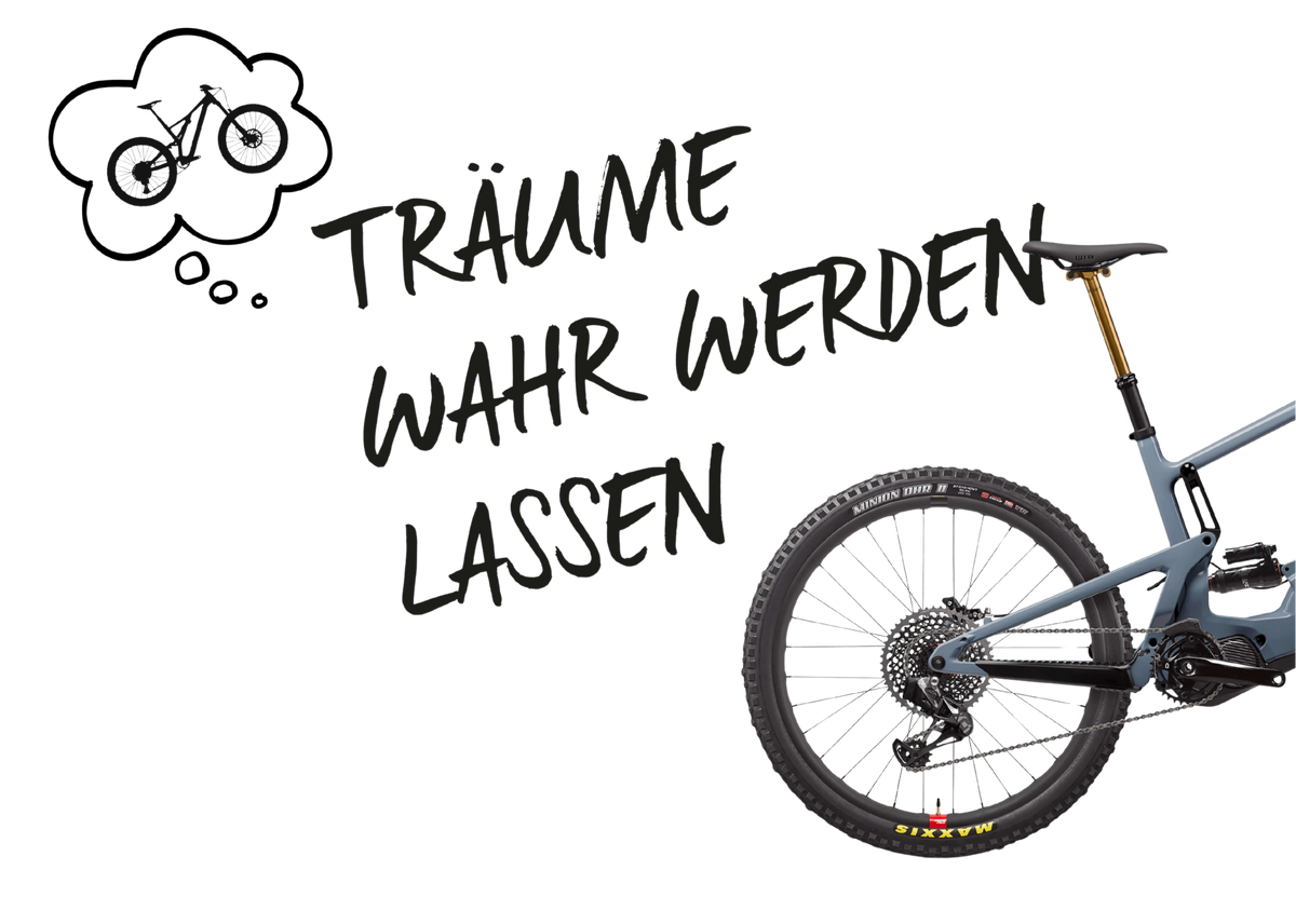 Teilansicht eines blauen Mountainbikes mit Hinterrad, Federgabel und Kettenschaltung, Text "Träume wahr werden lassen".