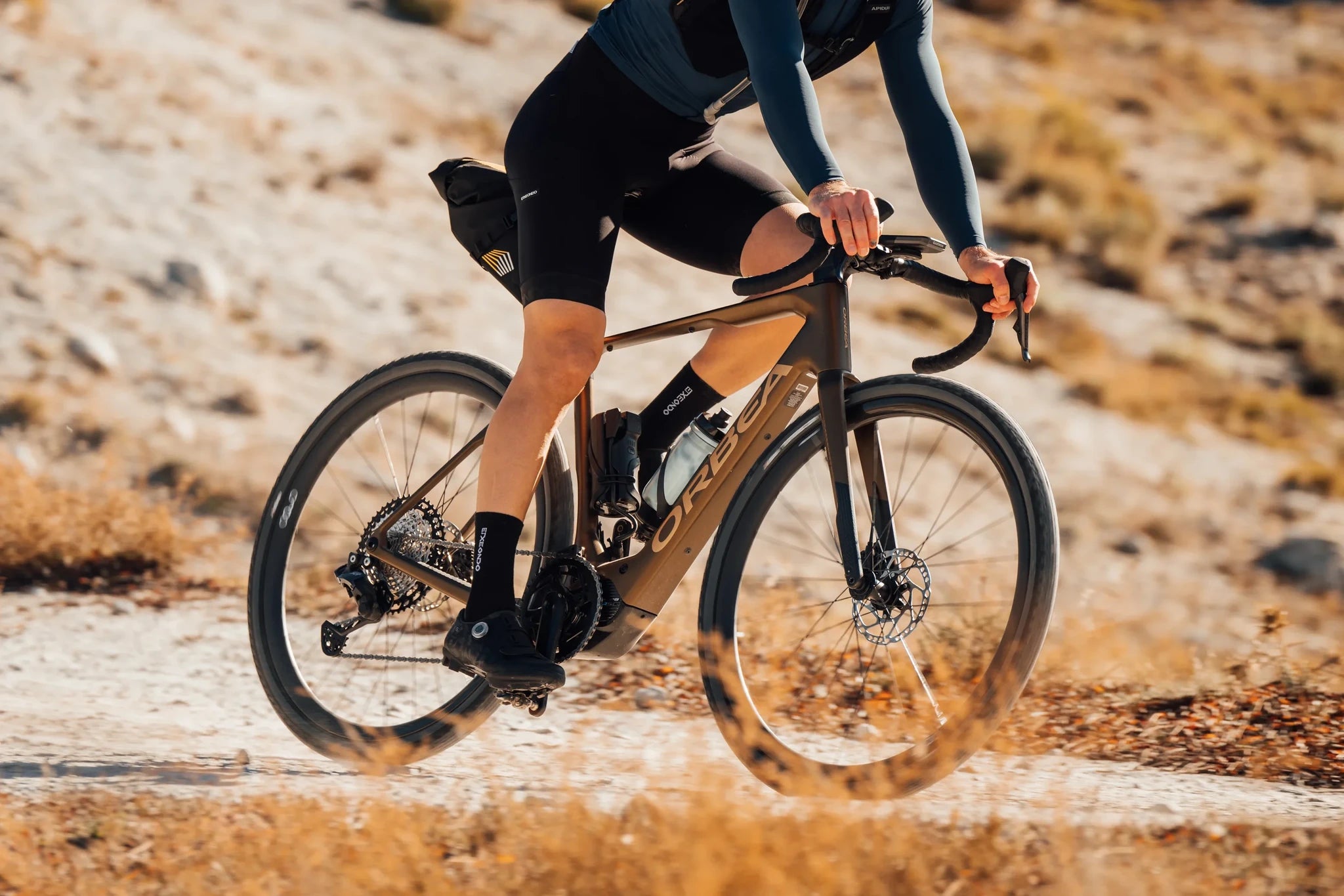 Radfahrer auf einem Orbea Gravelbike auf einem Schotterweg, ideal für Outdoor-Enthusiasten und Abenteurer.