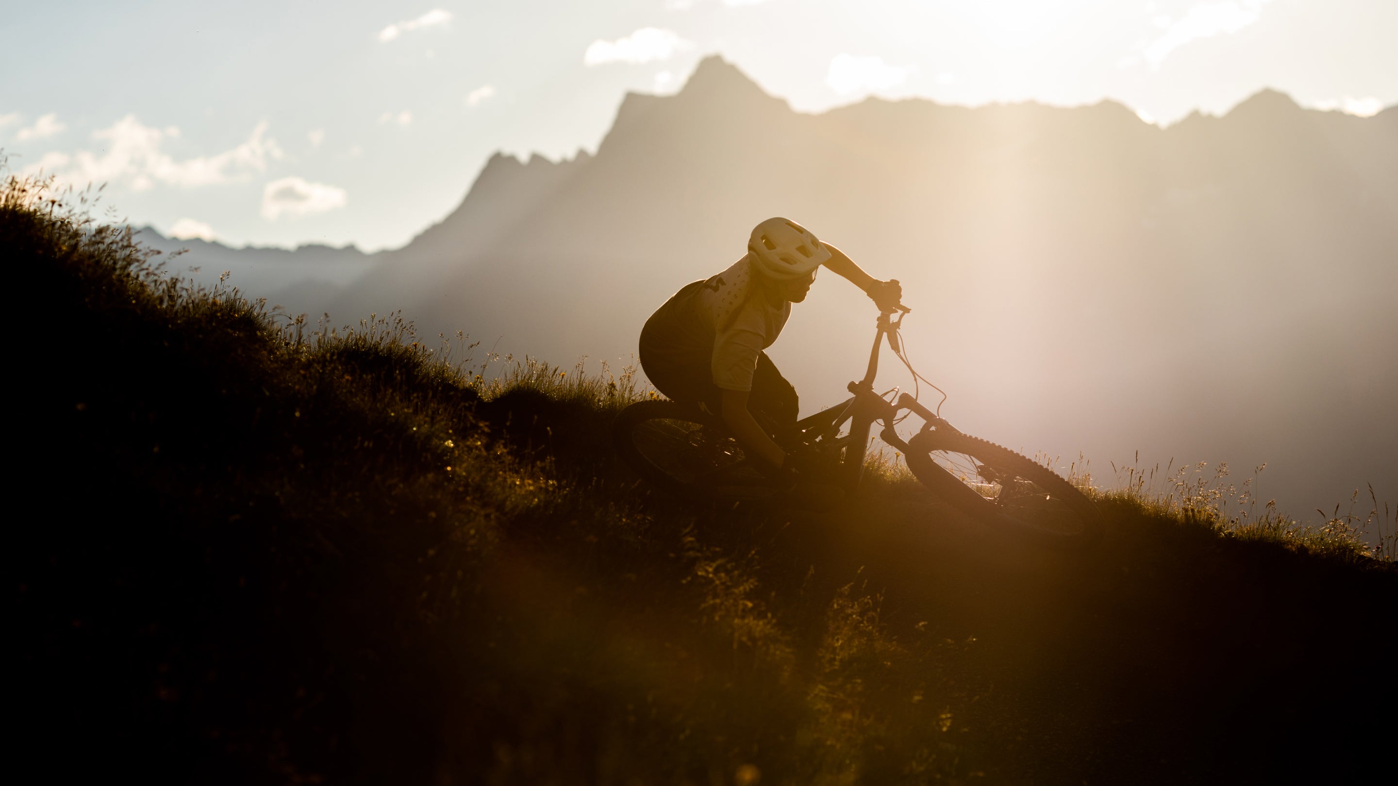 Fahrradfahrer bei Sonnenuntergang auf einem Specialized Turbo Levo SL Mountainbike in den Bergen.