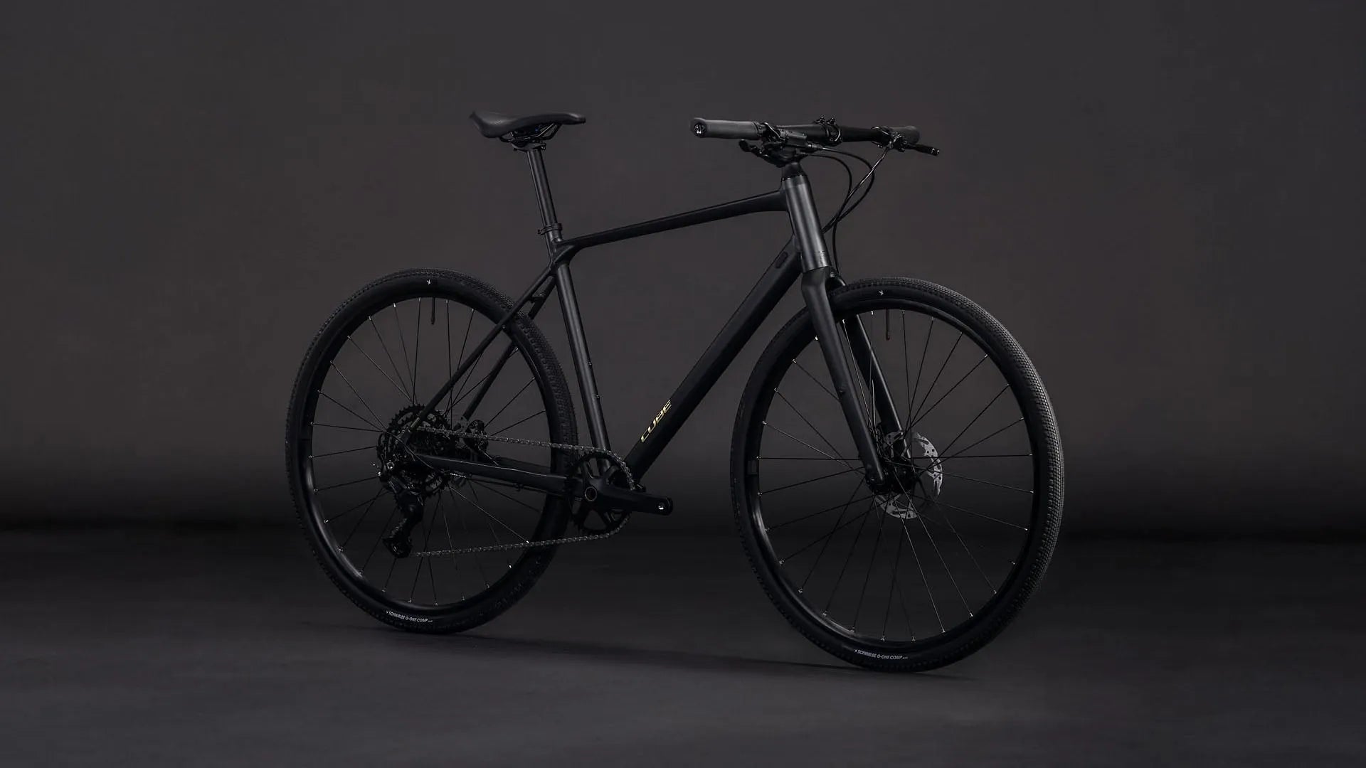 Schwarzes Cube NULANE PRO Modell ohne sichtbaren Schriftzug, auf grauem Hintergrund, geeignet für sportliche Fahrer.